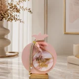 Ροζ στρογγυλό γούρι ρόδι από plexiglass με στρας και χρυσές λεπτομέρειες